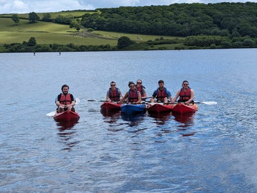 Travel Club Members Kayaking on a lake